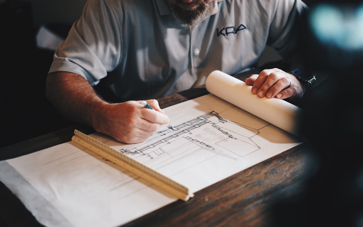 Architect drafting a construction blueprint by hand